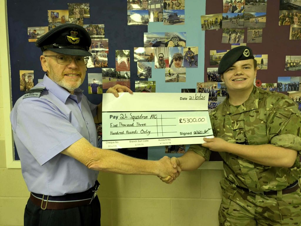 Squadron Commander, Flight Lieutenant Patrick Collins, receiving a cheque on behalf of the squadron from Cadet Corporal Nathaniel “Nat” Roberts.